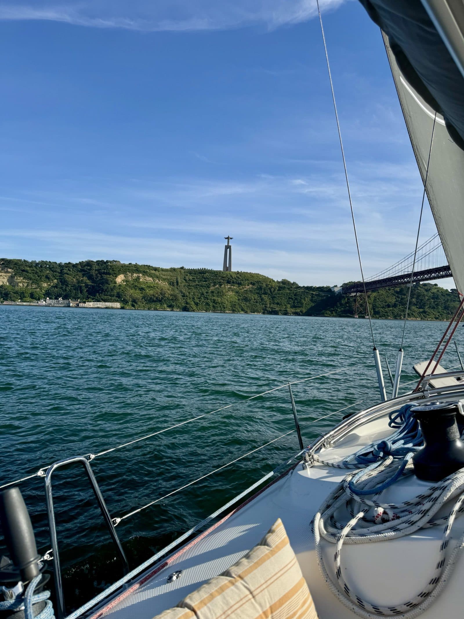 Sailing the Tagus past Cristo Rei and the 25 de Abril bridge
